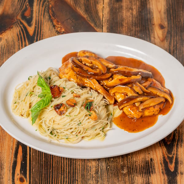 Chicken and mushrooms in a rich brown sauce, served with angel hair pasta and basil.